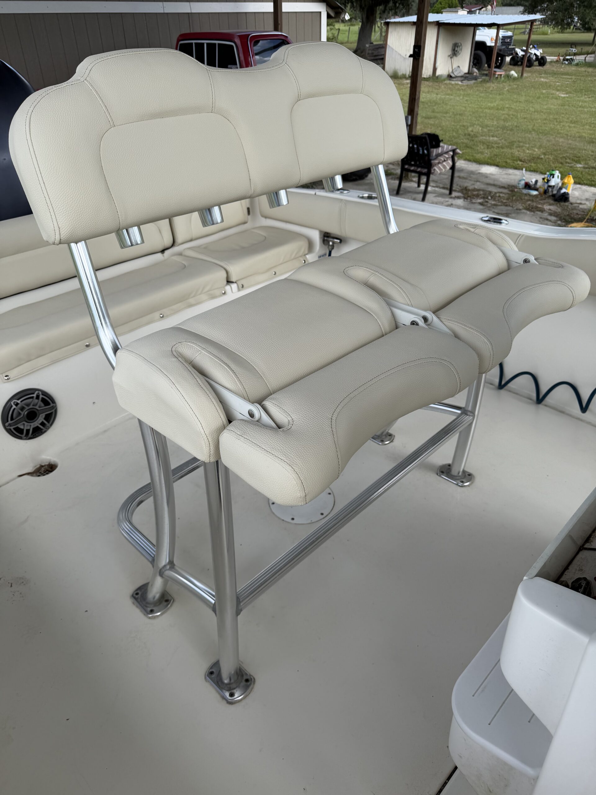 Back to back leaning post and helm seats reupholstered in cream marine vinyl