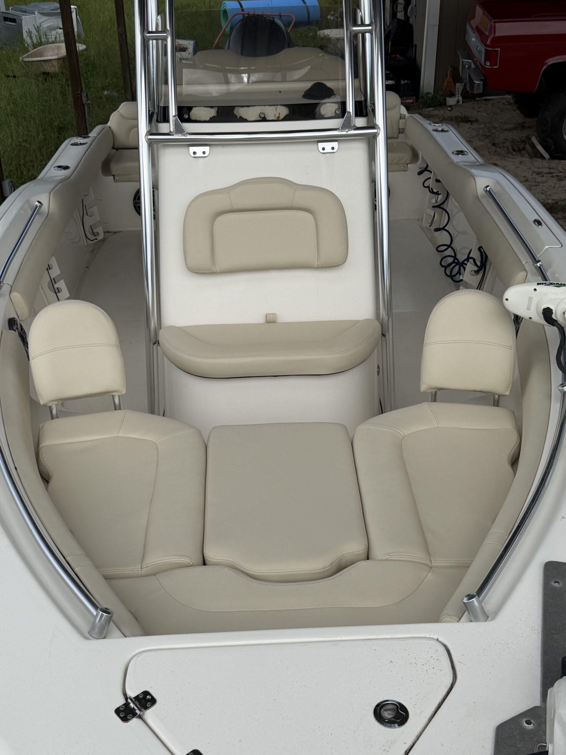 Center console bay boat with full interior reupholstered in cream marine vinyl